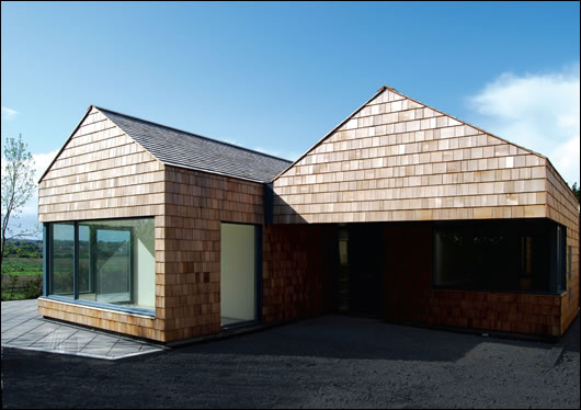 The building is orientated to maximise passive solar gains, further enhanced by a sunroom on the southern elevation