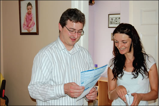 Doreen Donohoe examines her energy bills with Rory McConnon of Carlow Kilkenny Energy Agency in her upgraded home