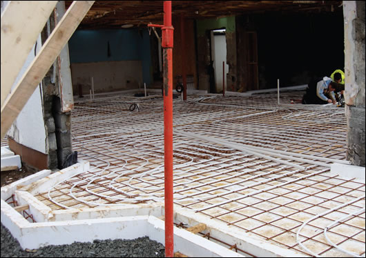Underfloor heating pipes laid on the insulated foundation system developed by Viking House