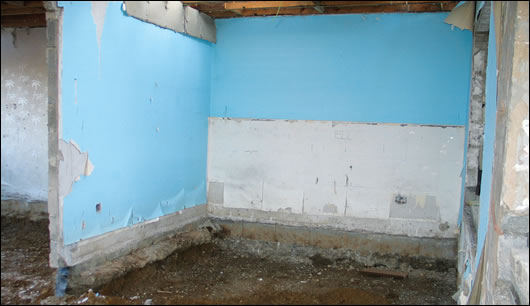 The shell of the building after it was gutted, with the sub-floor removed to enable the insulated foundation system to be installed