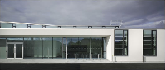 Office windows are placed high in the external walls to maximise daylight penetration while deep overhangs provide shading to public rooms Office windows are placed high in the external walls to maximise daylight penetration while deep overhangs provide shading to public rooms