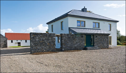 The externally insulated farm building; the extensively glazed timber extension affords views into the courtyard and beyond