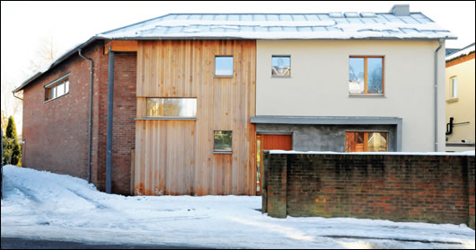 The road-facing north and east elevations have small windows and are clad in brick and rendered masonry to respect the existing streetscape