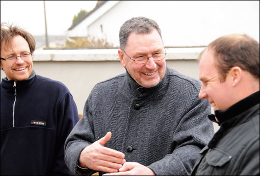 Homeowner Norman McMillan, centre, chatting with his son Doug, left, and builder Kevin Doyle of Doyson Construction