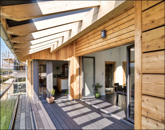 A large folding triple-glazed wall on the first floor divides the main living space from the porch A large folding triple-glazed wall on the first floor divides the main living space from the porch