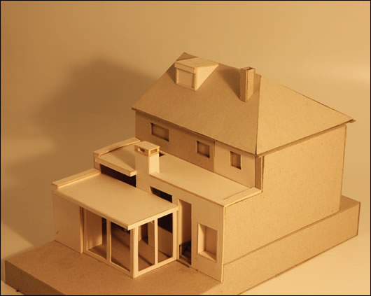a model showing the design of the upgraded house, with the extension configured as a kitchen/family room and utility space