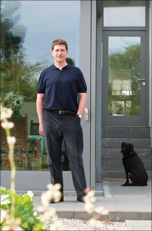 Eamon Ryan, standing outside his renovated home, is delighted to see projects like this become more and more common. He believes people are becoming convinced of the merits of retrofitting as they see the 
