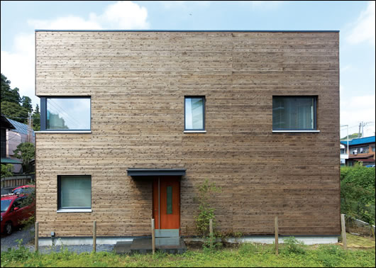 The home appears as a tall wooden crate