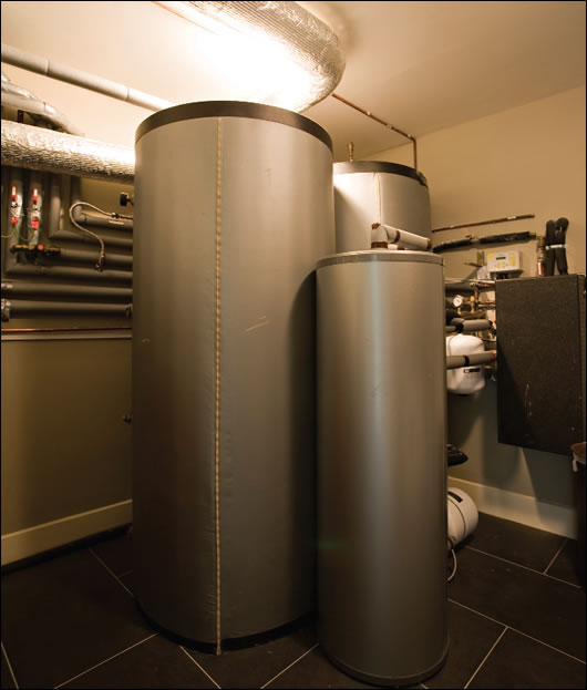 Solar panels at the house heat a sequence of highly insulated water cylinders