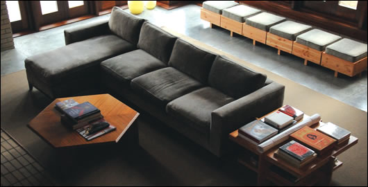 The double-height living area includes furniture designed by Lloyd Wright. Again, glazing and timber are used to create a modern yet natural ambiance The double-height living area includes furniture designed by Lloyd Wright. Again, glazing and timber are used to create a modern yet natural ambiance