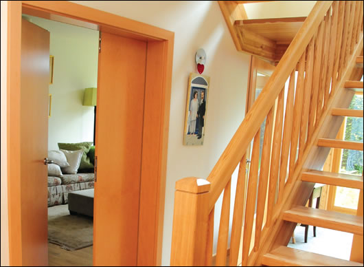 the entrance hall looking south towards the sun room (behind the timber stairs) with the living room to the left the entrance hall looking south towards the sun room (behind the timber stairs) with the living room to the left