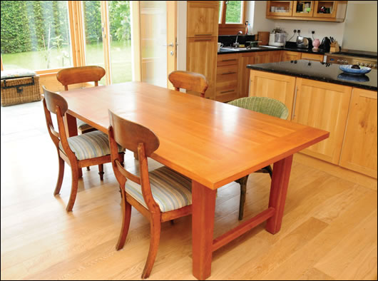 the kitchen table, with the hand-made kitchen by Eamon O’Sullivan and sun space in the backgroun the kitchen table, with the hand-made kitchen by Eamon O’Sullivan and sun space in the backgroun