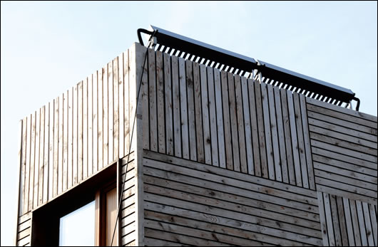 Solar vacuum tubes were installed on the cedar clad, stick-build timber frame extension to provide for hot water needs and they are orientated to maximise solar gain Solar vacuum tubes were installed on the cedar clad, stick-build timber frame extension to provide for hot water needs and they are orientated to maximise solar gain