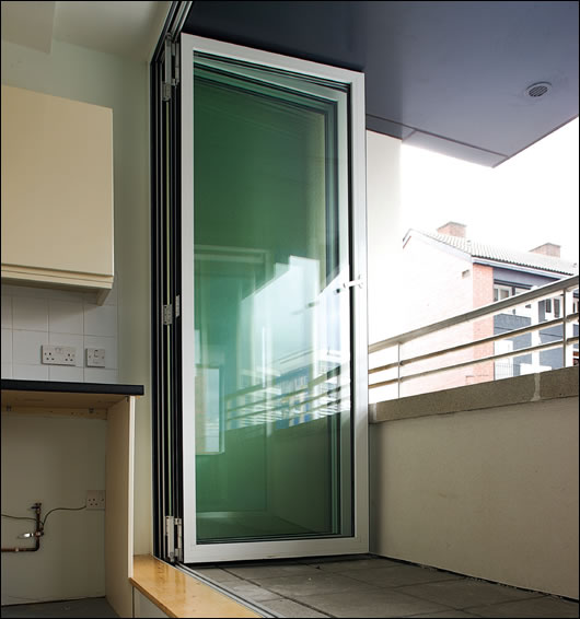 The Solarlux sliding glass system allows the balconies to remain fully exposed to the elements or, with the panels fully closed, gives the tenants use of the space during bad weather The Solarlux sliding glass system allows the balconies to remain fully exposed to the elements or, with the panels fully closed, gives the tenants use of the space during bad weather
