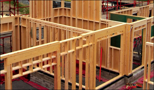 The timber frame system being erected The timber frame system being erected