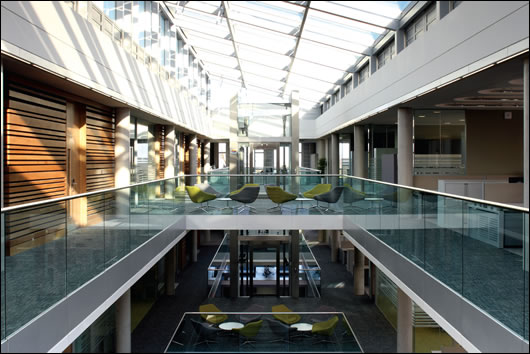 The offices are set around a large central atrium which aids ventilation and greatly increases natural light, with the added benefit of glazed balustrades The offices are set around a large central atrium which aids ventilation and greatly increases natural light, with the added benefit of glazed balustrades